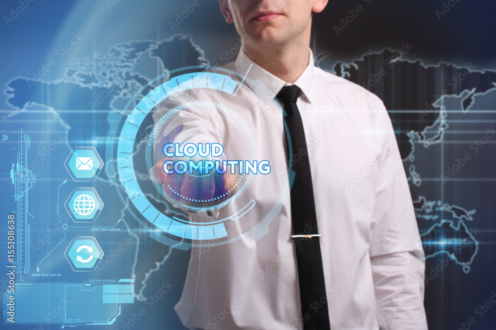Business, Technology, Internet and network concept. Young businessman working on a virtual screen of the future and sees the inscription: Cloud computing Business, Technology, Internet and network concept. Young businessman working on a virtual screen of the future and sees the inscription: Cloud computing