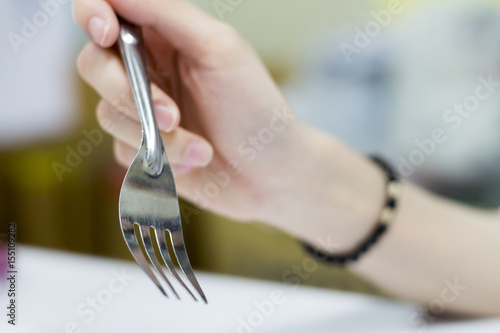 People are preparing a fork to eat.