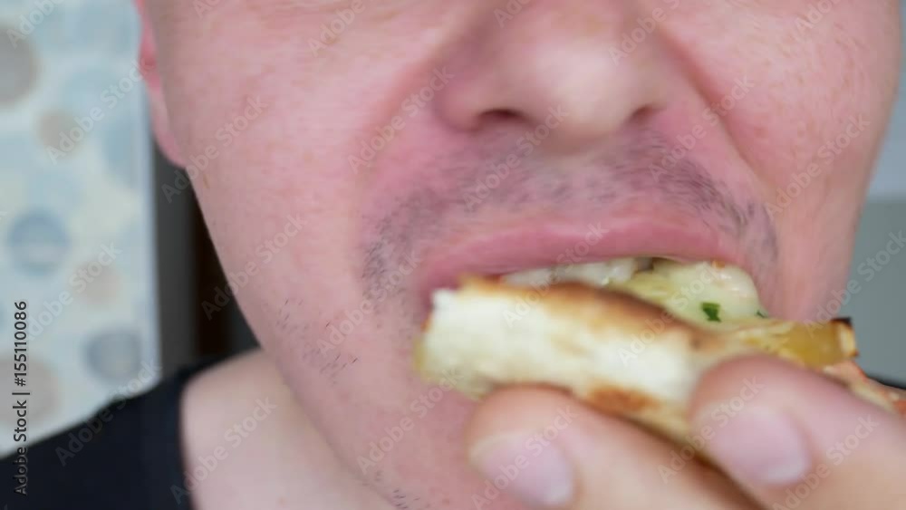 A Man With Light Hairlessness And Freckles on Cheeks Eats A Piece of Delicious Pizza Made from Fish, Green, Cheese, Vegetable Herbs, Parsley and Olives. The Pizza Eating Process Filmed by the Close Up A Man With Light Hairlessness And Freckles on Cheeks Eats A Piece of Delicious Pizza Made from Fish, Green, Cheese, Vegetable Herbs, Parsley and Olives. The Pizza Eating Process Filmed by the Close Up