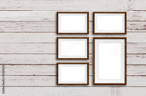 Five photo frames set on old painted wooden wall, decorative background