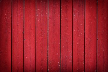 Rustic old weathered red wood plank background with vignette