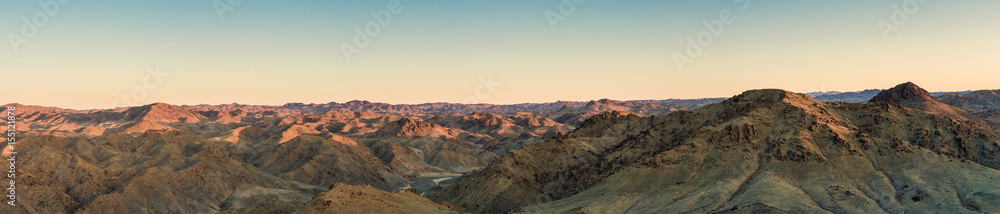 majestic prairie with mountains on background at sunny day  
