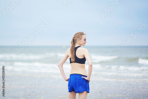 Fototapeta Naklejka Na Ścianę i Meble -  Healthy fitness runner girl on beach
