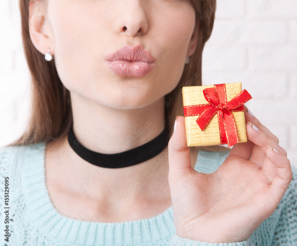 Present. Gift bos. Woman holding small gift box with ribbon.