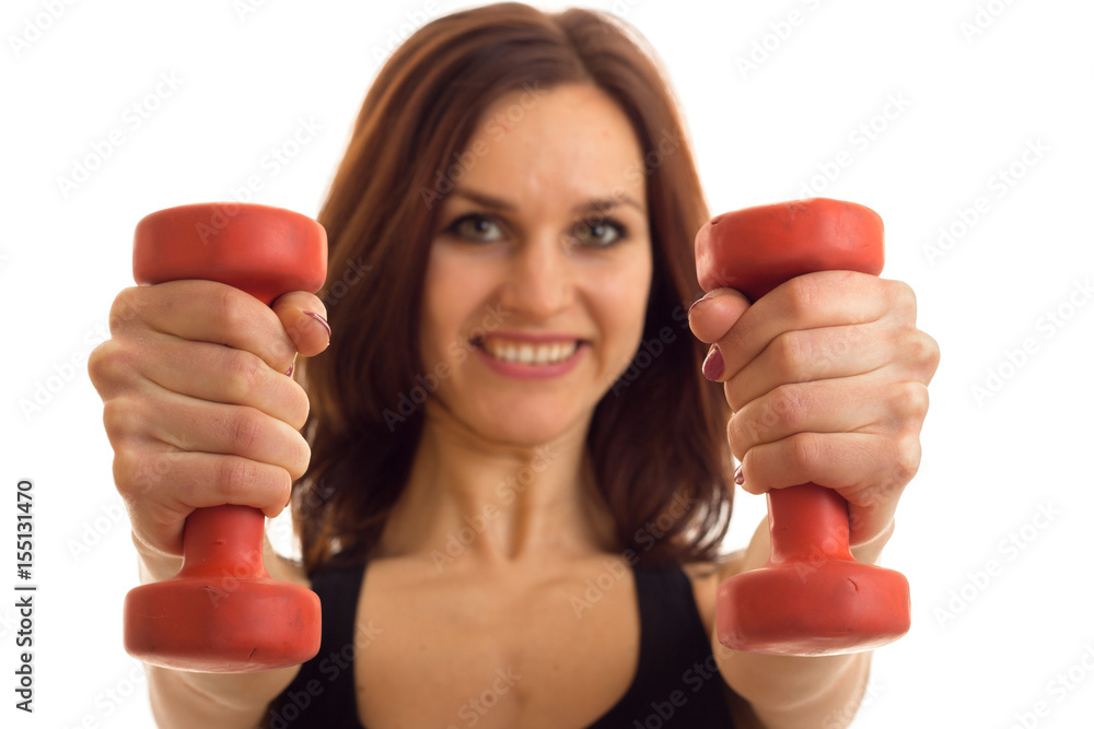 Portrait of beautiful sports girls that stretched forward dumbbells in hands close-up