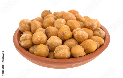 Serving of chickpeas with sea salt in a small red clay bowl isolated on a white background.