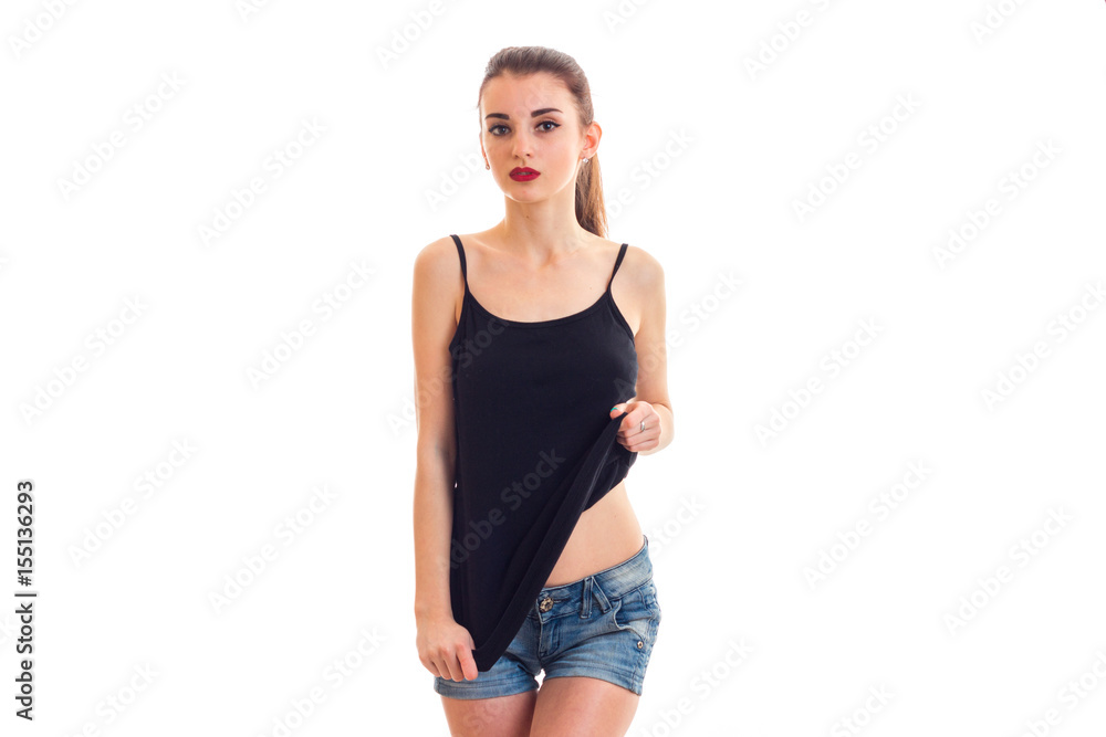 beautiful attractive girl in black t-shirt stands up straight and posing for the camera beautiful attractive girl in black t-shirt stands up straight and posing for the camera