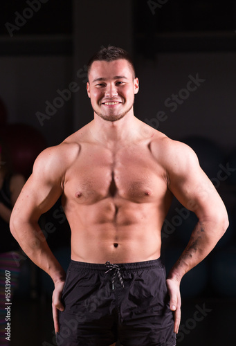 Young handsome muscular man bodybuilder posing