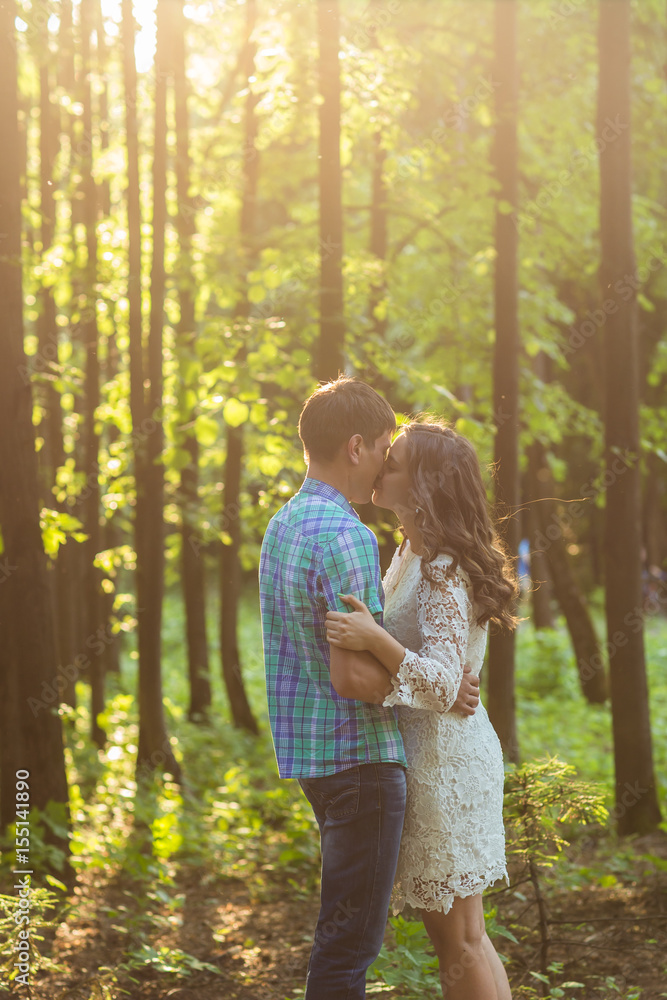 Young attractive couple in love kissing in summer nature