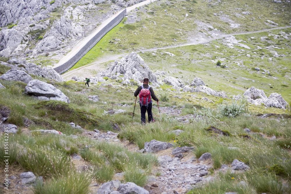 Hiker on Tulove grede, part of Velebit mountain in Croatia. 