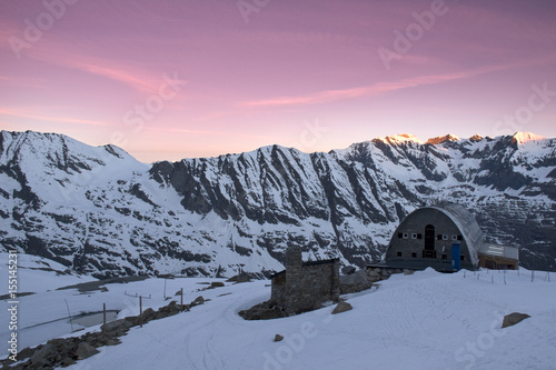 Il sole nascente ,illumina con magici colori le montagne che contornano il rifugio Vittorio Emanuele. photo