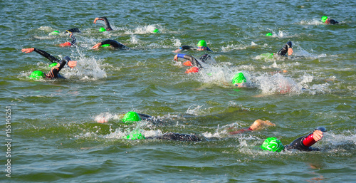   Competitors swimming in at the end of the swimming stage at the beginning of Triathlon.  photo