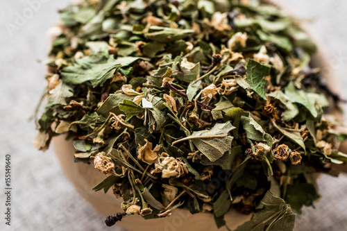 Dried Hawthorn / Crataegi folium cum flore in wooden ladle photo