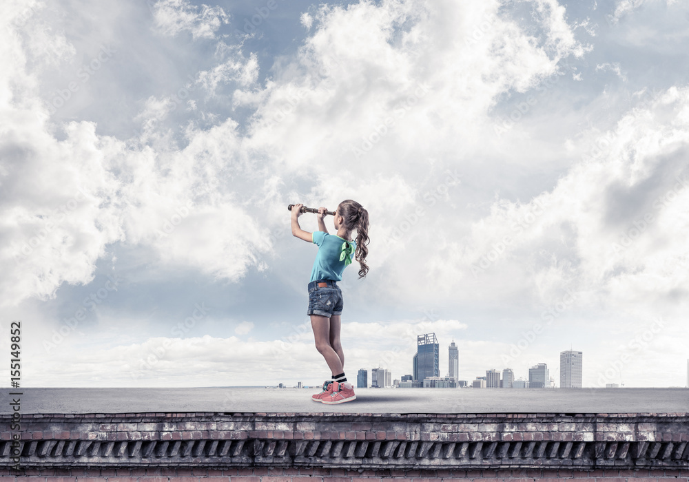 Concept of careless happy childhood with girl exploring this wor Concept of careless happy childhood with girl exploring this wor