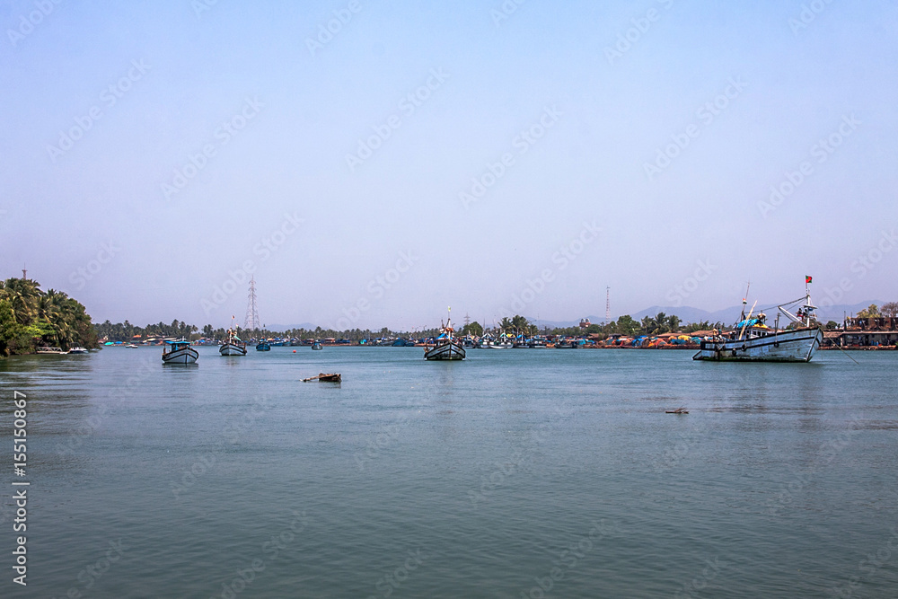tropical indian river with fisherman ships