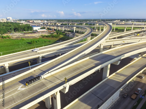 Aerial view massive highway intersection, stack interchange with elevated road junction overpass in the afternoon at Houston, Texas. This five-level freeway interchange carry heavy rush hour traffic. photo