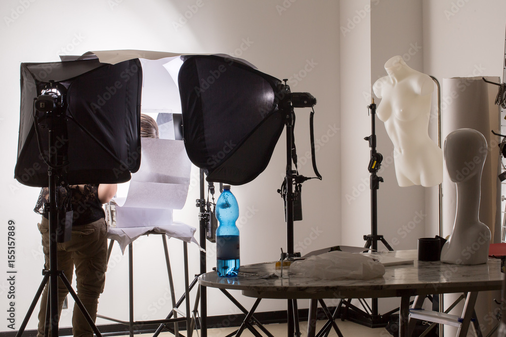 Photographic studio set up with assistant at work