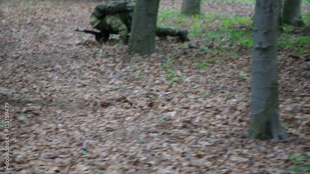 Guerilla warriors squad fall back in one formation carrying their guns in the forest bushes. War battlefield maneuvers training. Guerilla warriors squad fall back in one formation carrying their guns in the forest bushes. War battlefield maneuvers training.