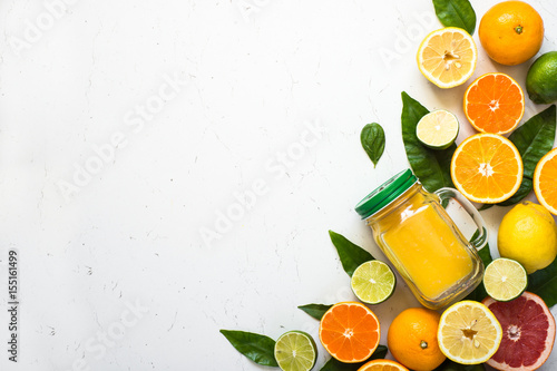 Citrus juice smoothie and ingredients. Fresh Fruit background on white.