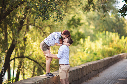 Young couple kissing in park, love concept