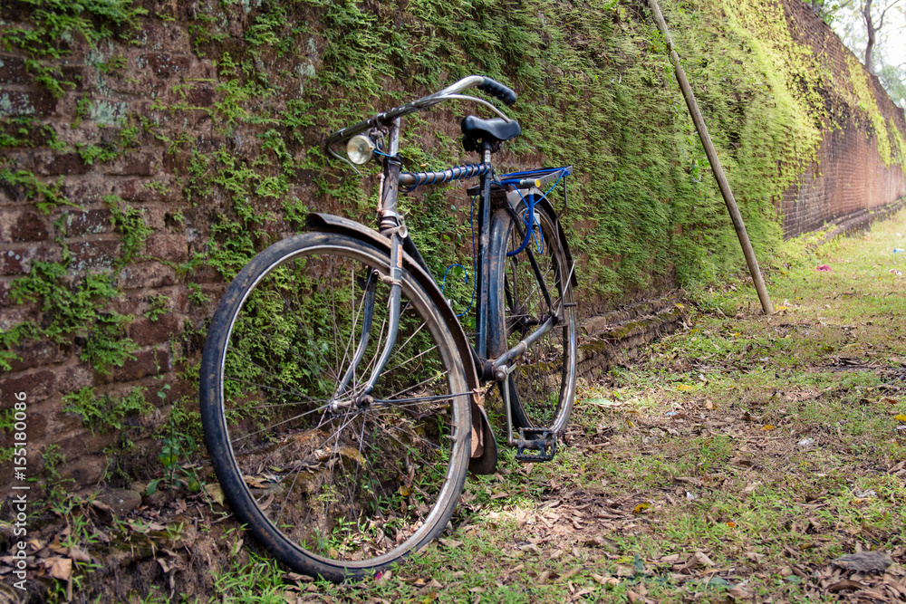An old bicycle leaning against one of the old brick walls of the ancient city of Polonnaruwa, Sri Lanka. An old bicycle leaning against one of the old brick walls of the ancient city of Polonnaruwa, Sri Lanka.