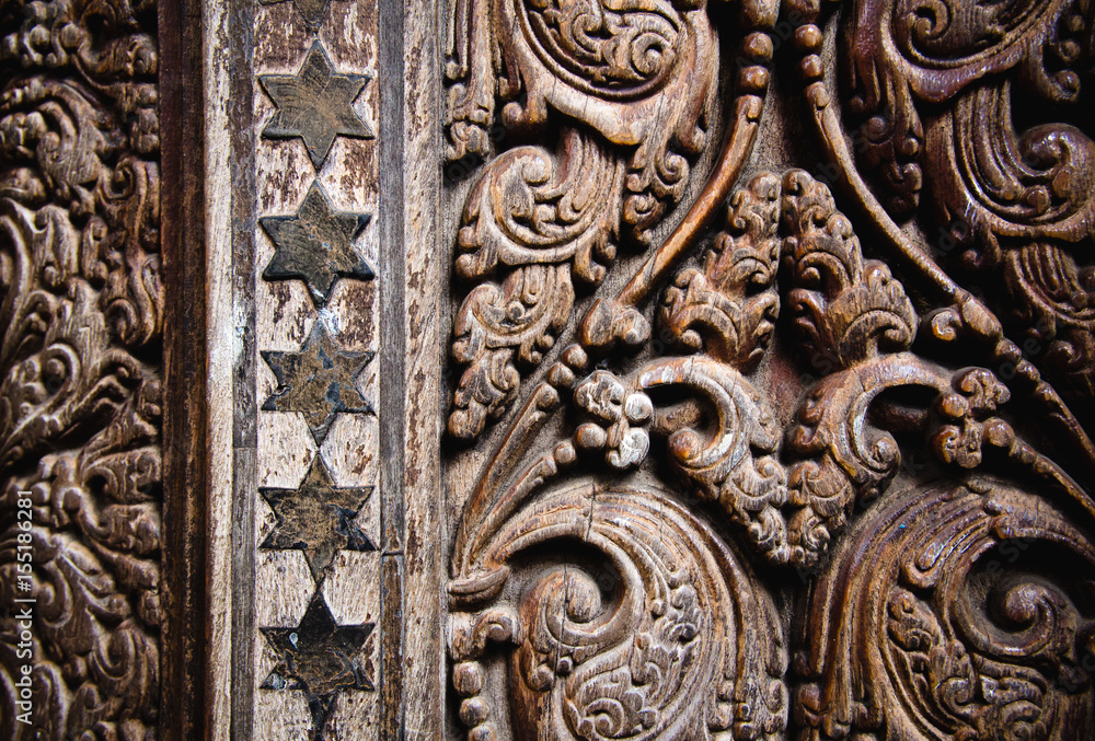 Beautiful wood carving on ancient door in Buddhist temple in Kandy, Sri Lanka.