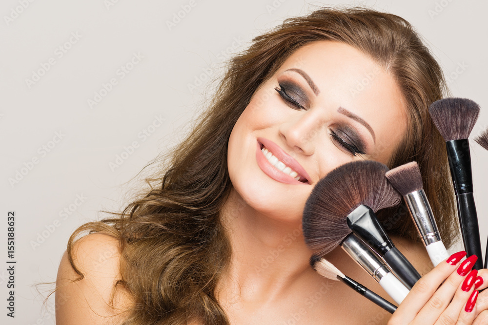 Beautiful makeup artist woman with various brushes Beautiful makeup artist woman with various brushes