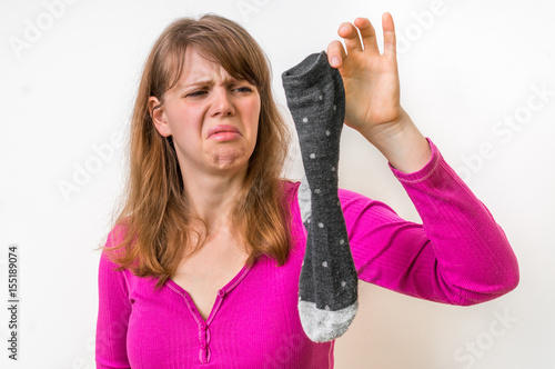 Woman holding dirty stinky socks
