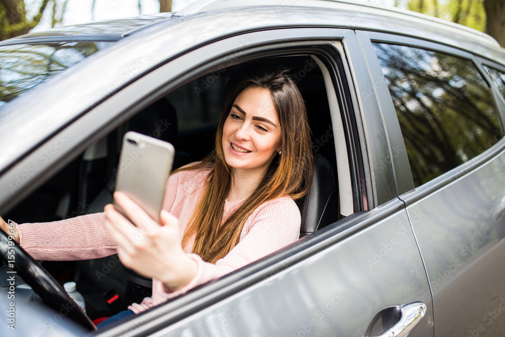 woman hand holding smartphone on window her car