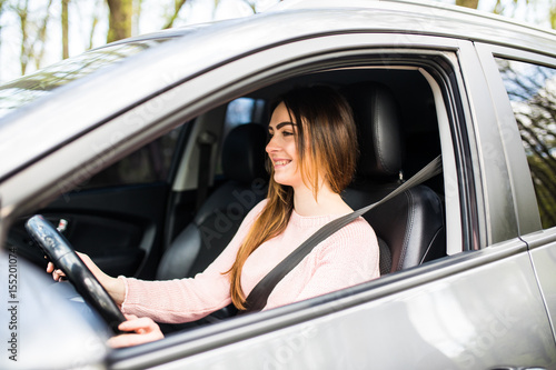 Young woman driving her car with safity belt on street road. Safe drive © F8  \ Suport Ukraine