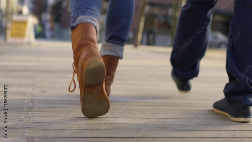 Closeup Of Young Couple's Feet As They Walk Through City Closeup Of Young Couple's Feet As They Walk Through City