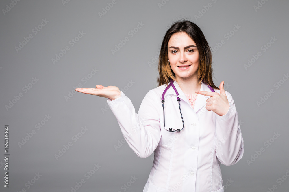 Female medical doctor showing copy space. Woman in white professional uniform with stethoscope on neck. Female medical doctor showing copy space. Woman in white professional uniform with stethoscope on neck.