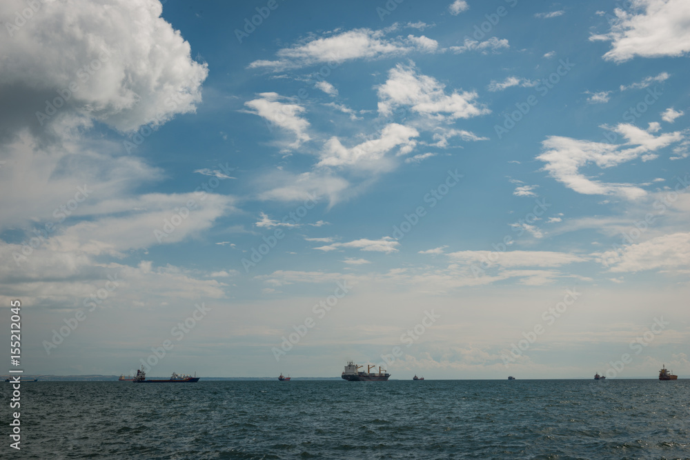 Beautiful beach view boats on sea and cloudy sky;