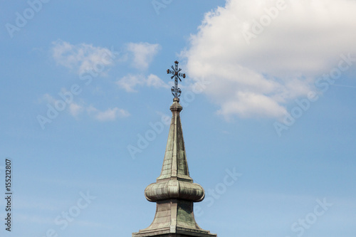 Christian cross at the top of a steeple church tower, typical Austro Hungarian baroque style of an Orthodox church of Serbia.. photo