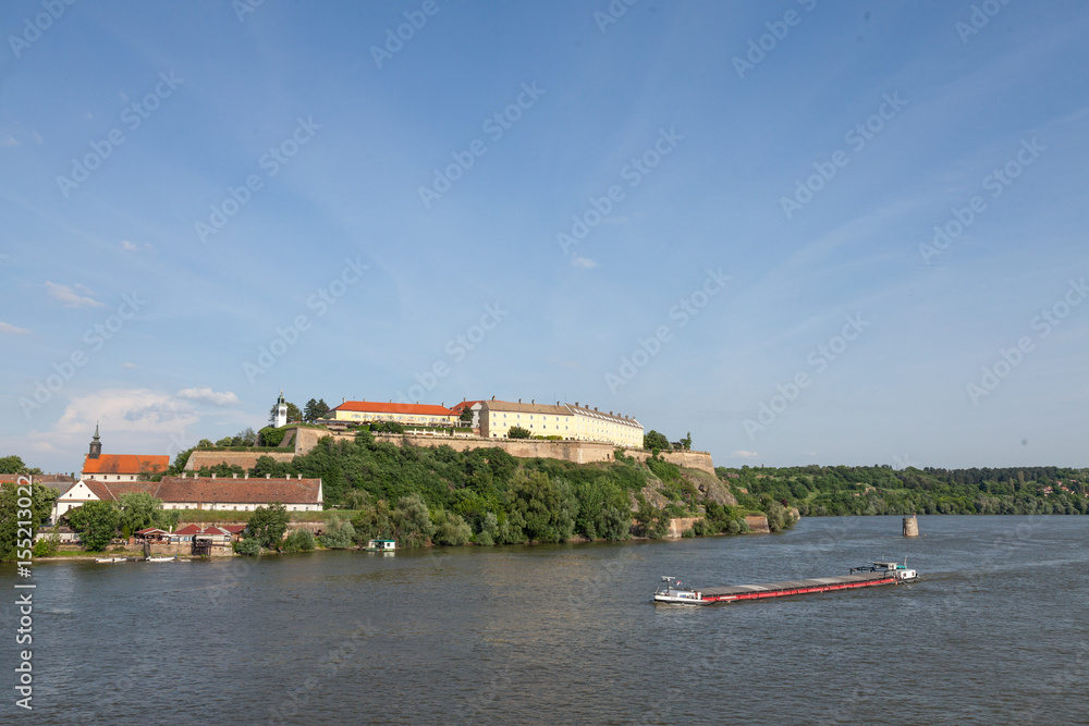 Barge passing in front of Petrovaradin fortress in Novi Sad, Serbia. This castle is one of the symbols of Serbia, Danube river is the main axis of navigation in Europe