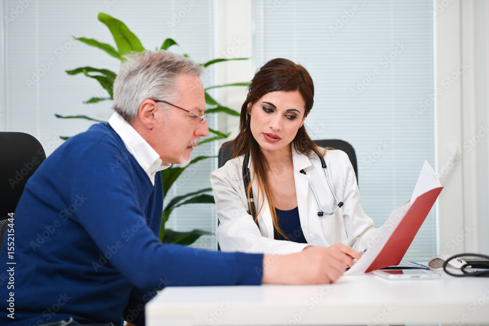 Fototapeta premium Doctor speaking to her patient while showing some documents