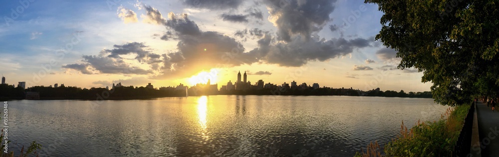 Jacqueline Kennedy Onassis Reservoir and silhouette building with sunset in panorama