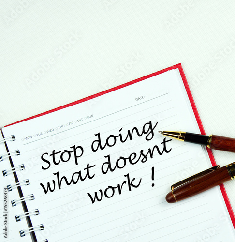 "Stop doing what doesnt work !" words on note book with pen