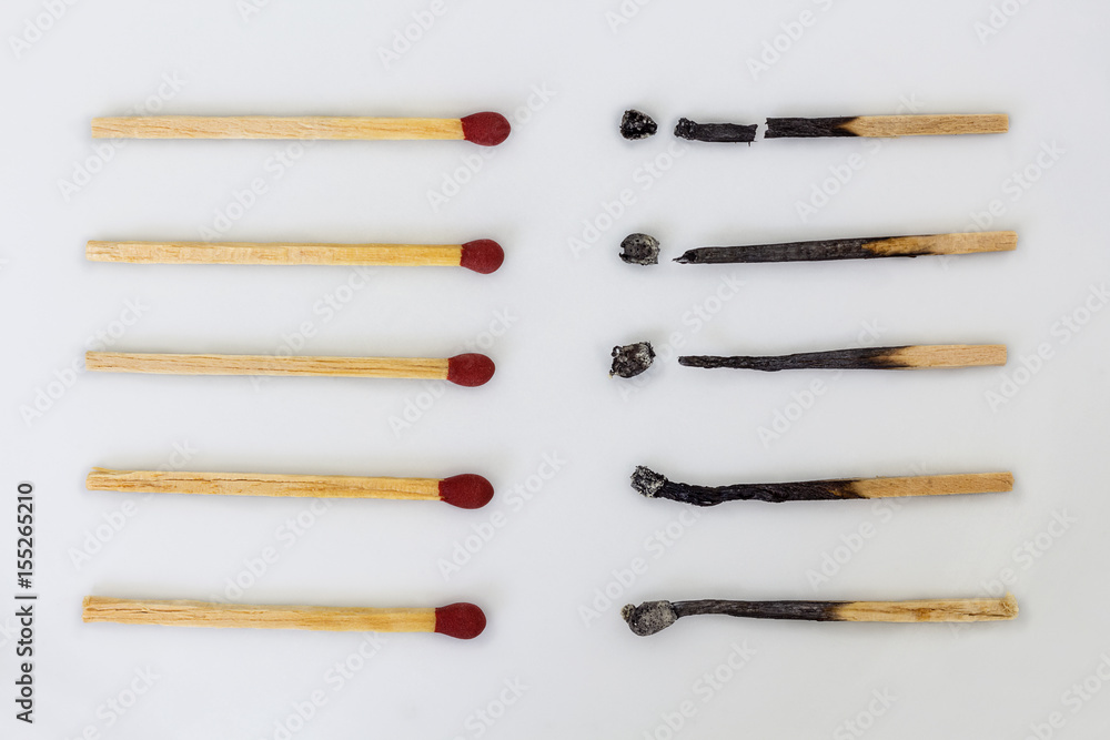 Burnt matchsticks and new matchsticks on white background. Different stages of matchsticks. Burnt matchsticks and new matchsticks on white background. Different stages of matchsticks.