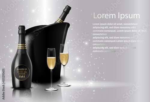 Wineglass with black wine bottles of champagne in a bucket 