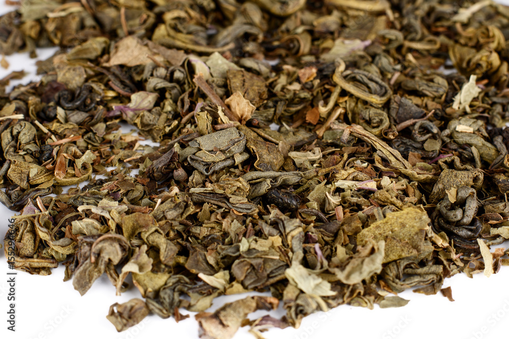Green and black tea leaves on white background Green and black tea leaves on white background