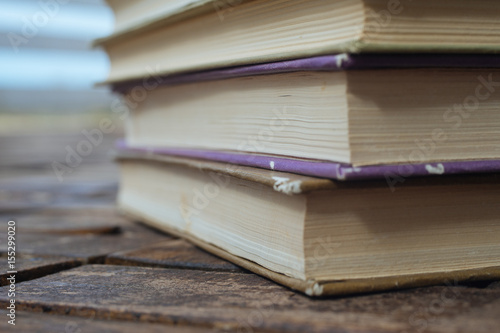 Stack old books on wooden background