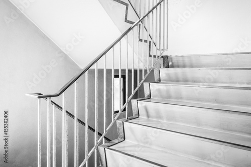 Concrete staircase with metallic handrail at modern buiding
