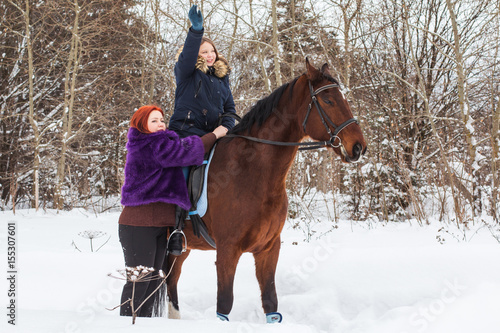 Teenager girl, mom and horse in a winter © keleny