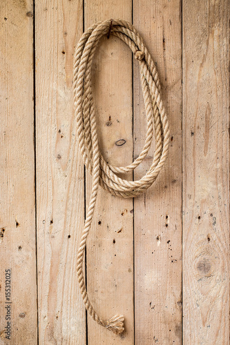 Brown string hanging on wooden wall