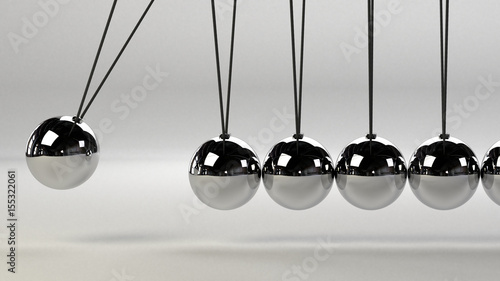 cause and effect concept, metal Newton's cradle on a white background