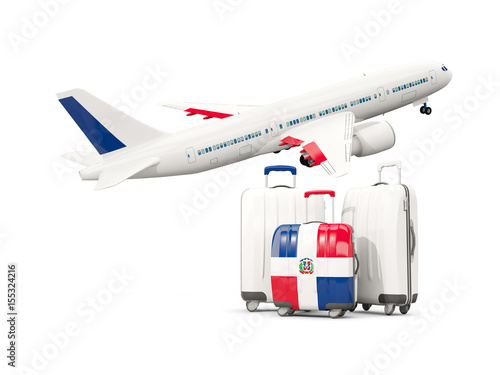 Luggage with flag of dominican republic. Three bags with airplane