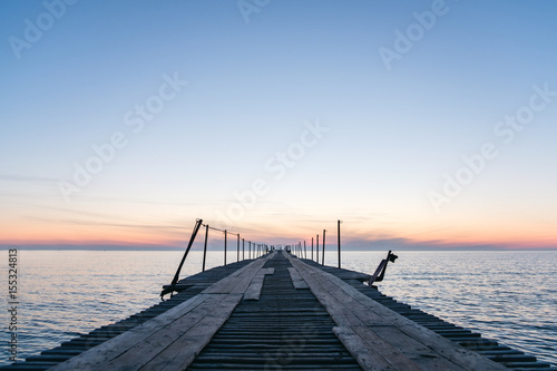 Fototapeta Naklejka Na Ścianę i Meble -  Vacation and Holiday concept - Wooden pier between sunset