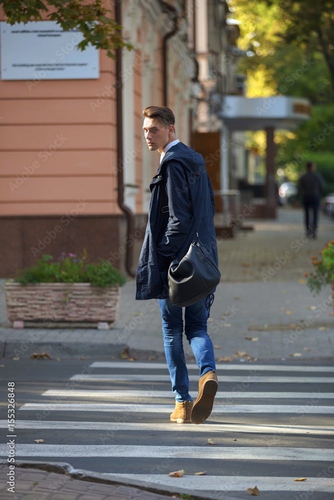 Hipster guy walking down the street, urban style