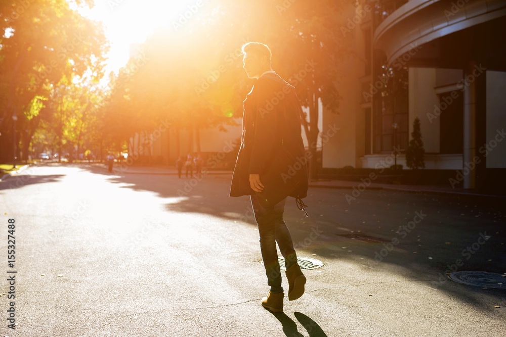 Hipster guy walking down the street, urban style Hipster guy walking down the street, urban style